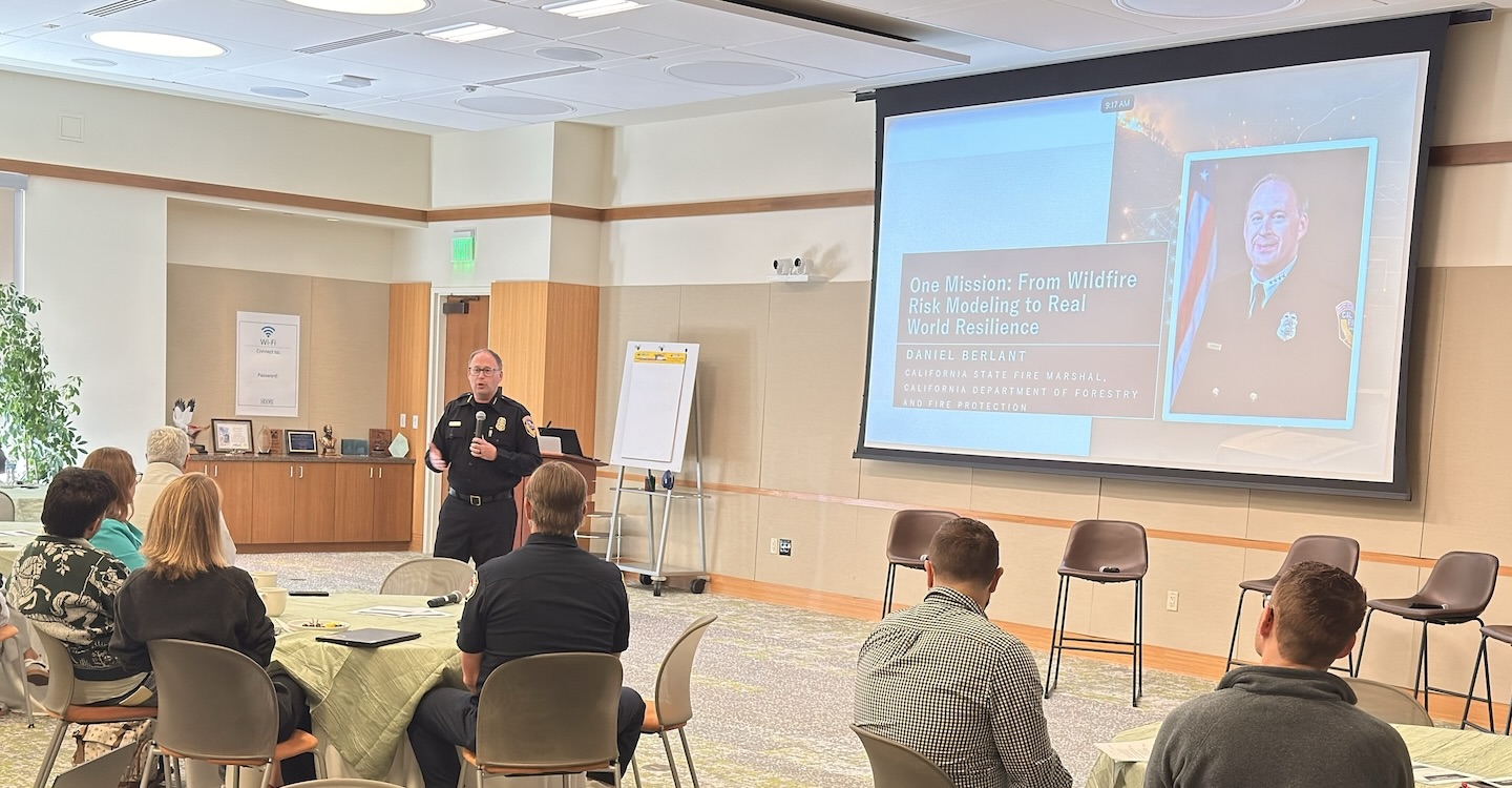 California State Fire Marshal Daniel Berlant stands in front of the audience during his keynote on the first day of the summit.