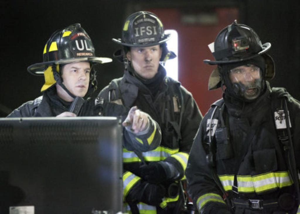 three firefighters in front of computer