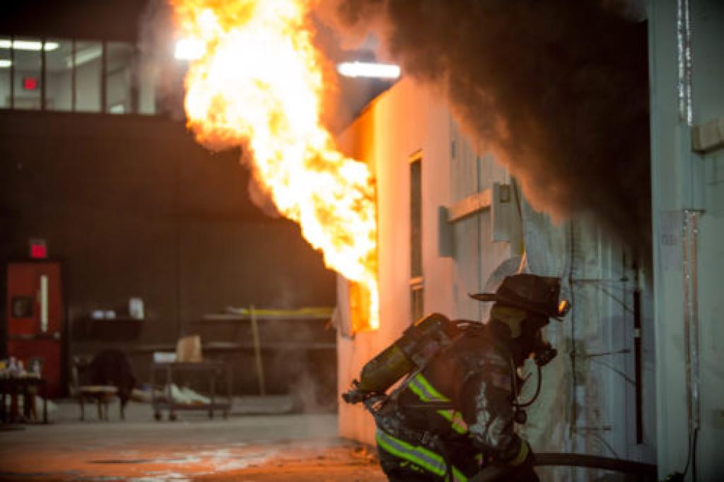 Fire billowing from metal container window