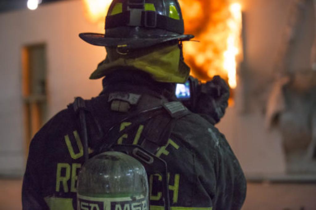 Fire fighter in front of flames