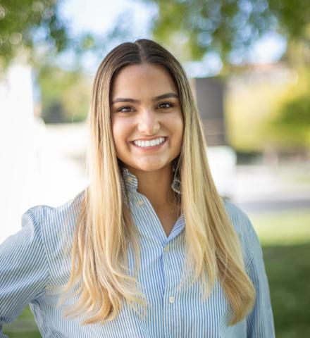 woman in blue shirt with long blonde hair