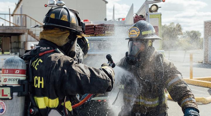 Two firefighters in a training exercise 