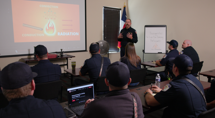 Fire instructor teaches a firefighting training course on the Fire Safety Academy to a group of firefighters 