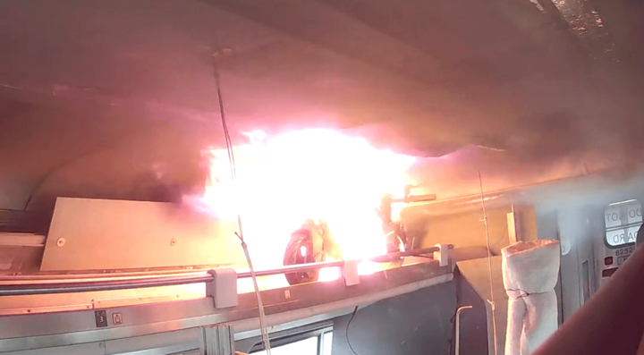 Flames are visible from an e-scooter during an experiment to examine the impact of thermal runaway-initiated e-mobility device fires on a passenger railcar