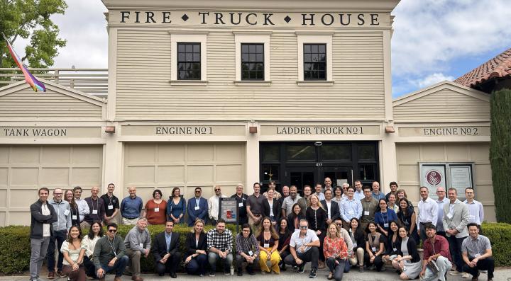 Group photo of wildfire risk modeling leaders in front of The Fire Truck House at Stanford University