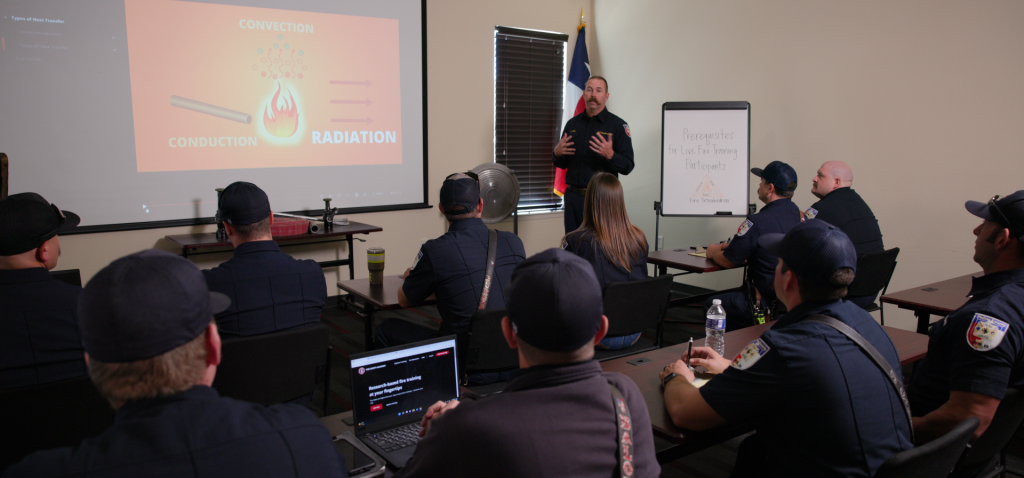 Fire instructor teaches a firefighting training course on the Fire Safety Academy to a group of firefighters