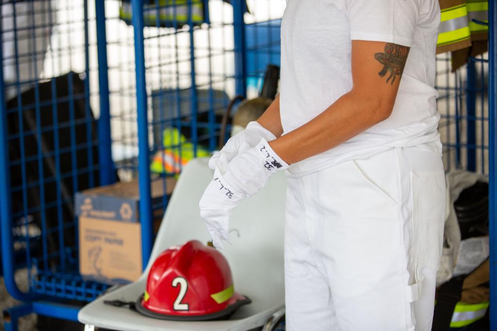 Firefighter putting on cotton under gloves