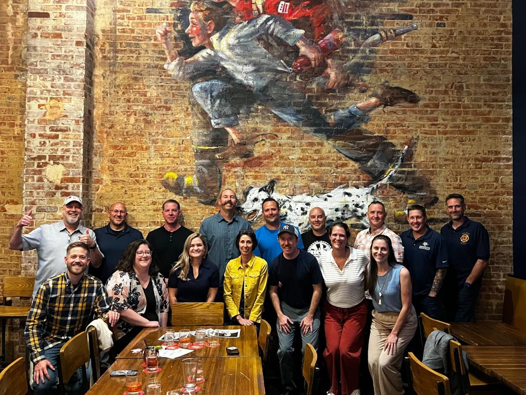 TAC members lined up for a group photo during a dinner and firefighter-themed trivia night
