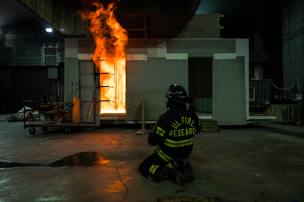 A ULRI fire safety laboratory technician is on standby as the double-room compartment reaches flashover