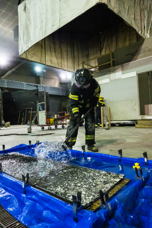 ULRI fire safety lab tech removing the wood flooring and submerging it in water