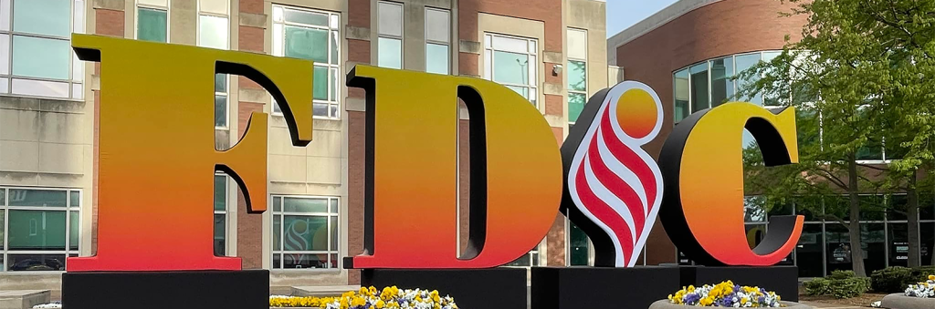 Large sign in front of a building spelling out FDIC