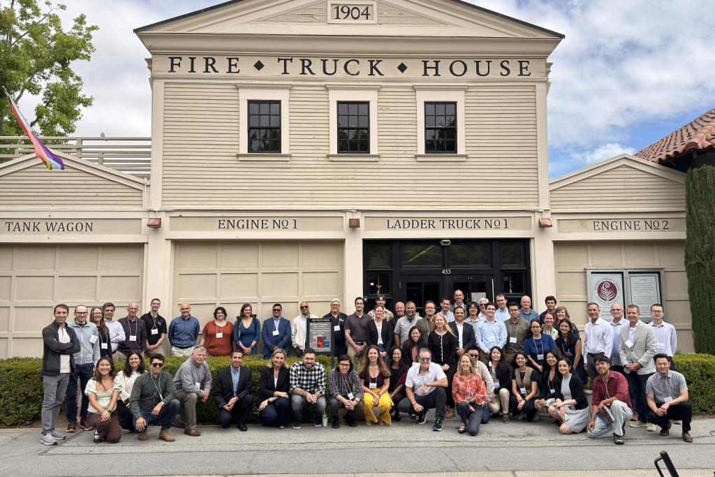 Group photo of wildfire risk modeling leaders in front of The Fire Truck House at Stanford University