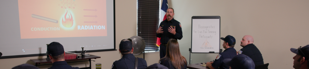 Fire service instructor presents at the front of a classroom