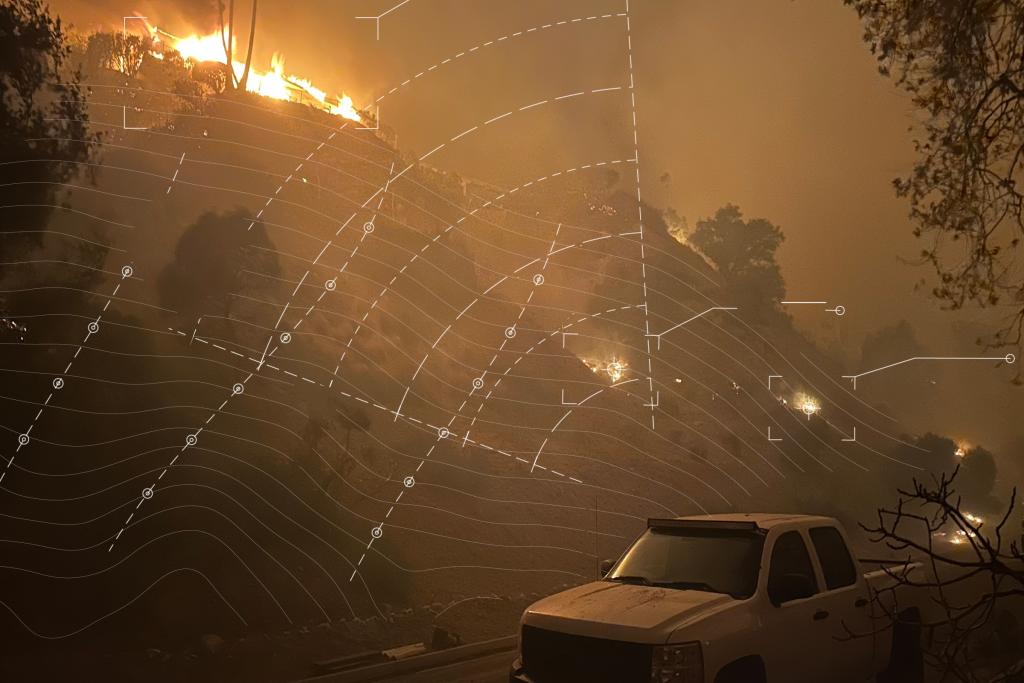 Wildfire spreading across a hillside at night with white contour lines and markers overlaid on top representing wildfire risk modeling