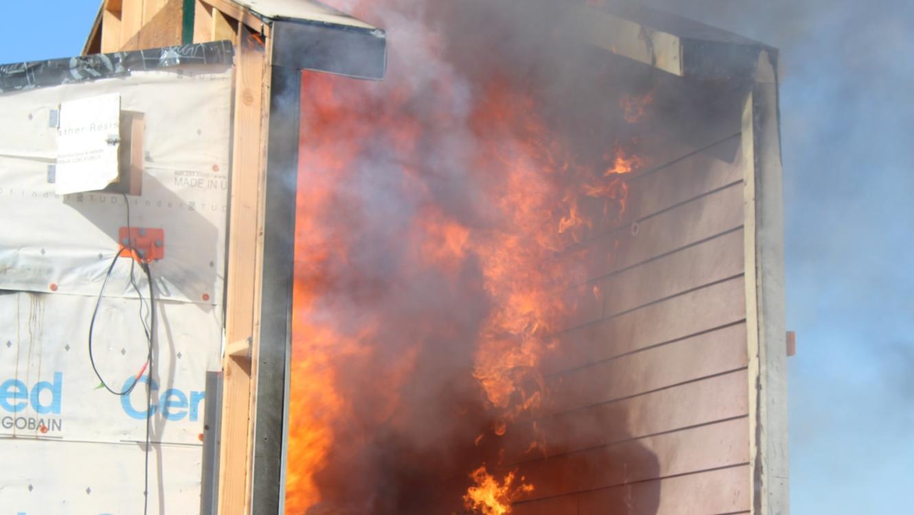 Structure-to-structure fire spread with noncombustible siding.