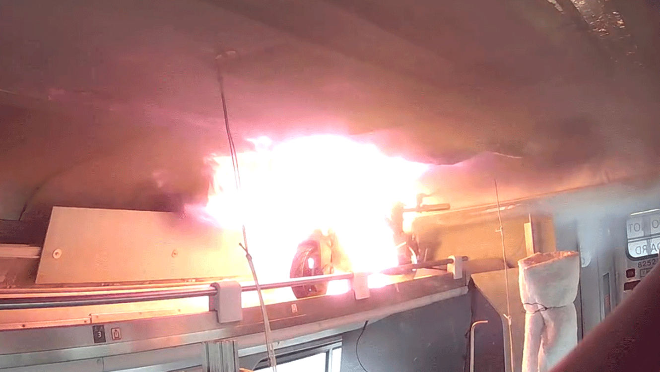 Flames are visible from an e-scooter during an experiment to examine the impact of thermal runaway-initiated e-mobility device fires on a passenger railcar