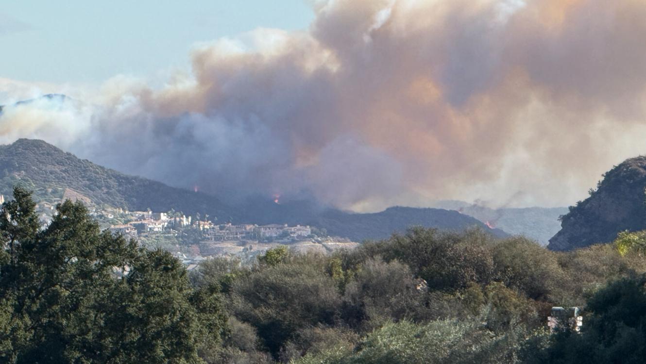 A wind-driven plume of smoke from fire spreading from wildland into the built environment during the Palisades Fire in Southern California in January 2025