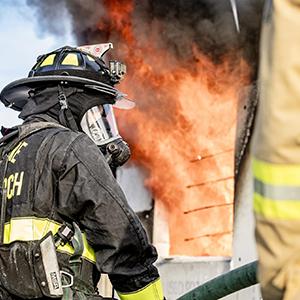 Firefighter standing outside of a structure fire