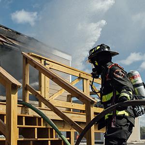 Firefighter holds the hoseline during search and rescue experiments