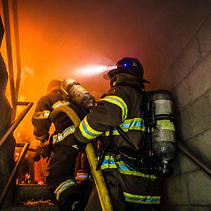 Firefighters conduct structural firefighting