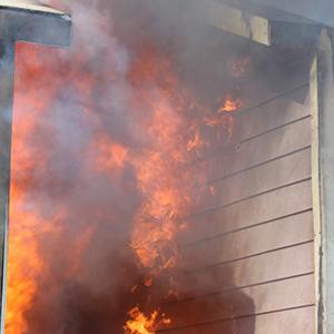 Flashover impacting a target structure with siding material during WUI heat transfer testing