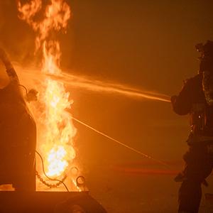 Full-scale electric vehicle fire experiment testing suppression tactics.