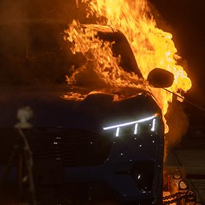 Full-scale electric vehicle fire experiment testing burning behavior.