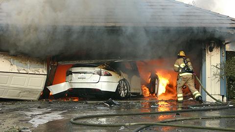 Firefighters respond to an electric vehicle fire inside a residential structure garage.