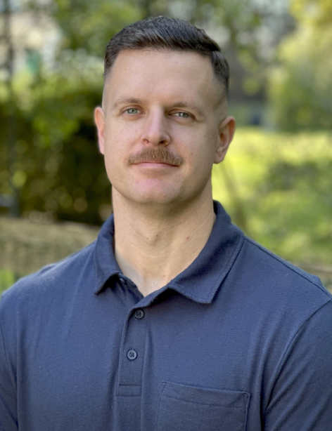 Andrew Hitchens wearing a blue polo shirt