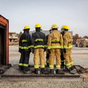 Mannequins outfitted in firefighter PPE in front of a fireground exposure simulator for study exploring PAH ingress