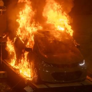 A fully involved vehicle fire captured during a series of EV fire experiments