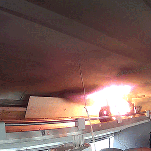 Flames are visible from an e-scooter during an experiment to examine the impact of thermal runaway-initiated e-mobility device fires on a passenger railcar