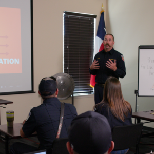Fire service instructor presents at the front of a classroom